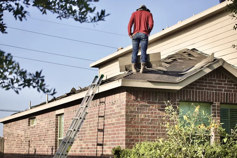 Professional roofer working on a residential roof in Westerly